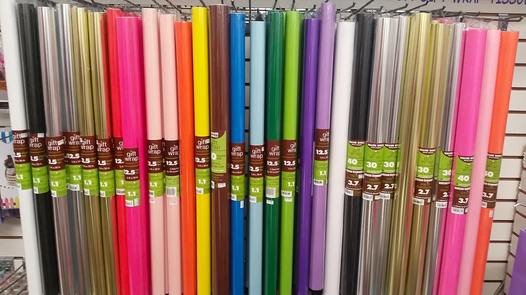 Rainbow rack of gift wrap and cellophane rolls at Capt. Party