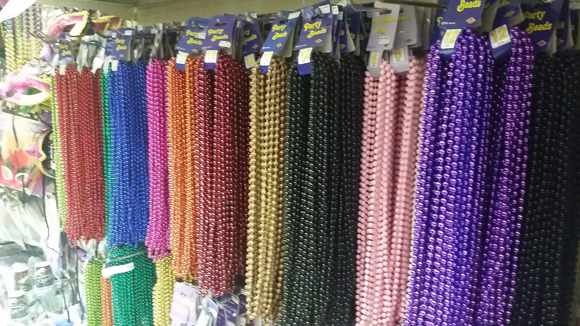 Wall of Mardi Gras bead necklaces in many colors