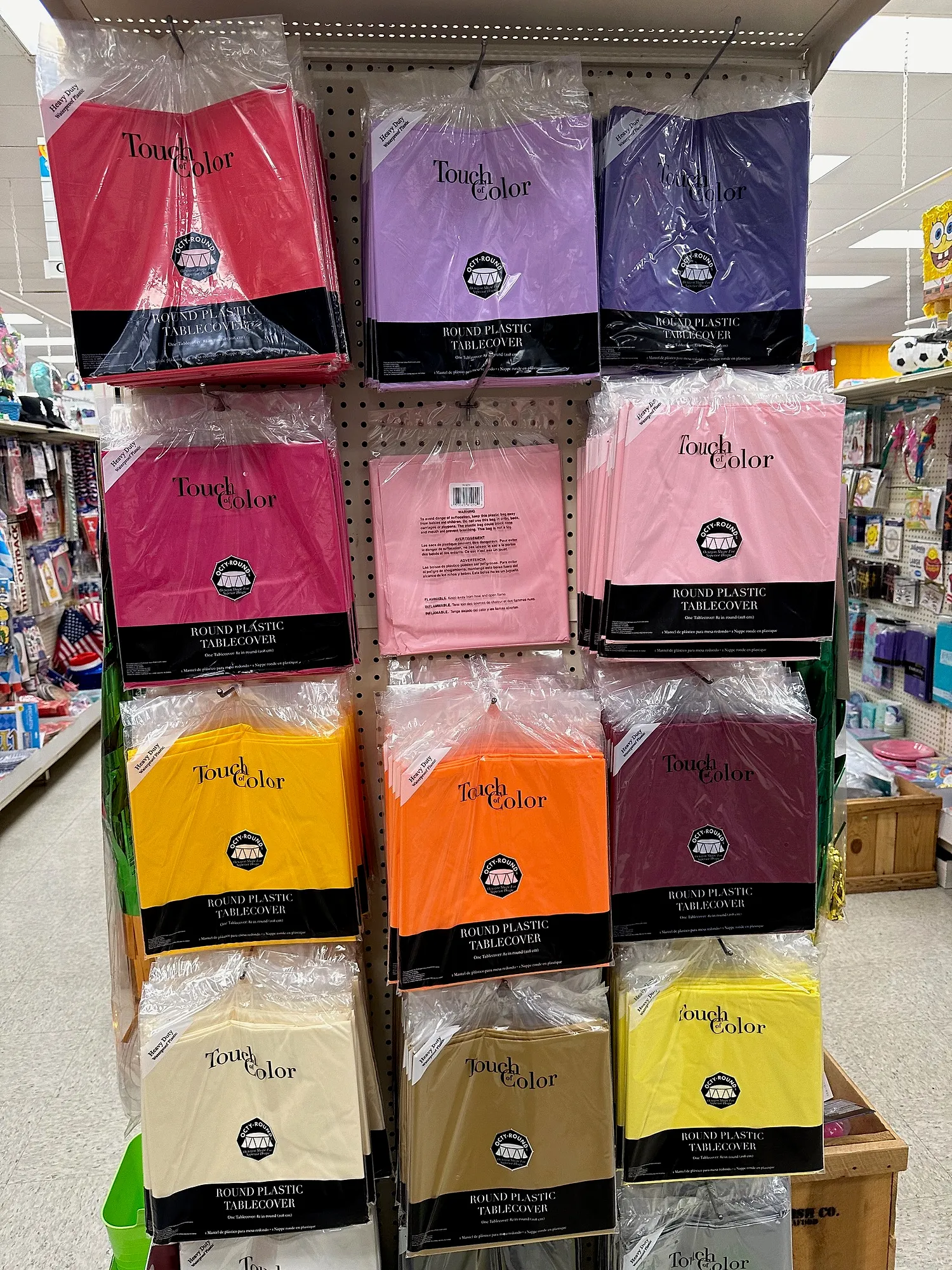 Spinner rack of solid-color plastic table covers